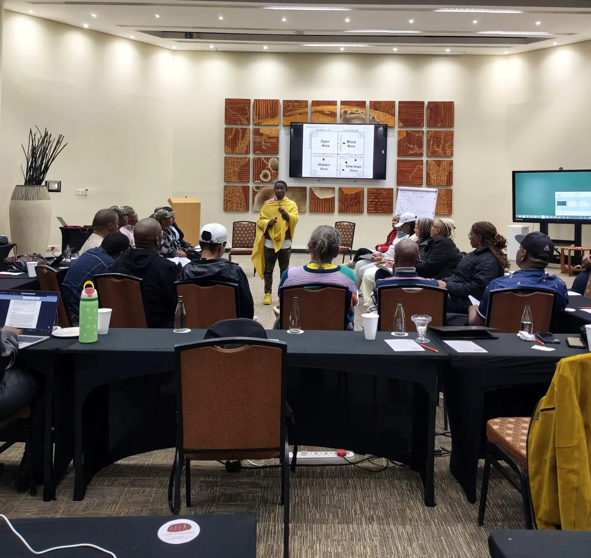 Delegates seated at a team building workshop in a conference room