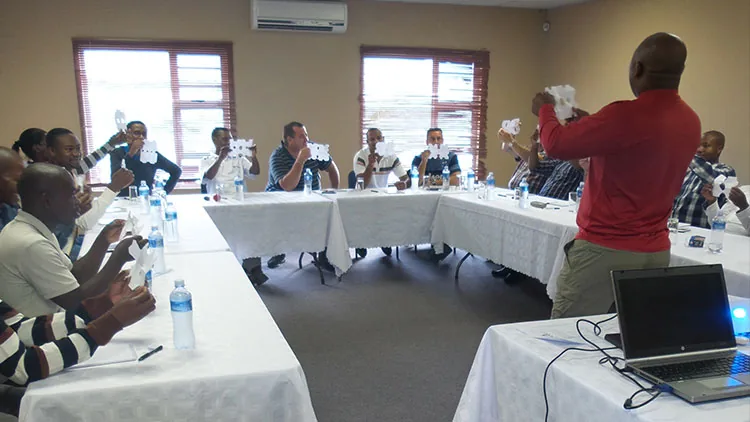 Training session in a conference room with delegates at U-shaped tables